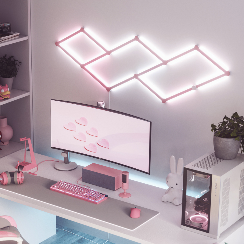 Nanoleaf Lines Thread-enabled color-changing smart modular backlit light lines skin mounted to a wall above a battlestation. Matte pink. HomeKit, Google Assistant, Amazon Alexa, IFTTT.